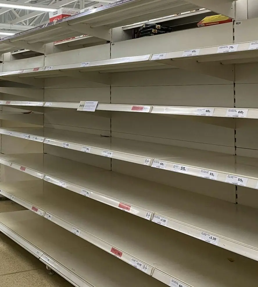 Góndola de supermercado con estantes vacíos